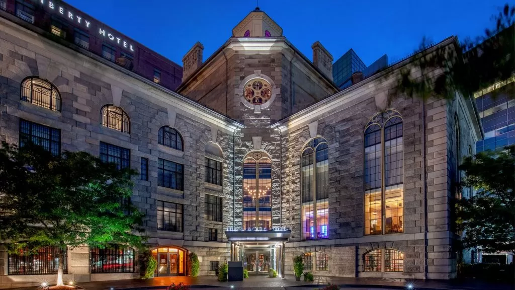 photo shows the stunning exterior of The Liberty luxury hotel, with colorful stained glass windows.
